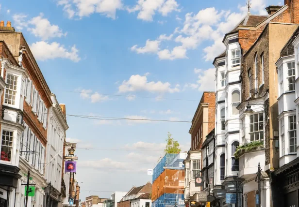 A street view showing mixed commercial and residential property architectures within our core Surrey and South West London service radius.